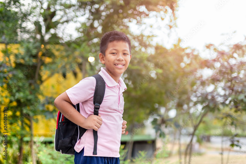 Happy asian school boy in uniform with backpack walking back home. Happy asian school boy in uniform with backpack walking back home.