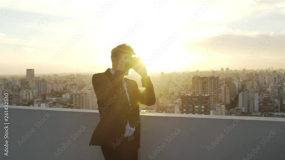 Point of view shot of mature businessman using virtual reality glasses while standing on terrace Point of view shot of mature businessman using virtual reality glasses while standing on terrace