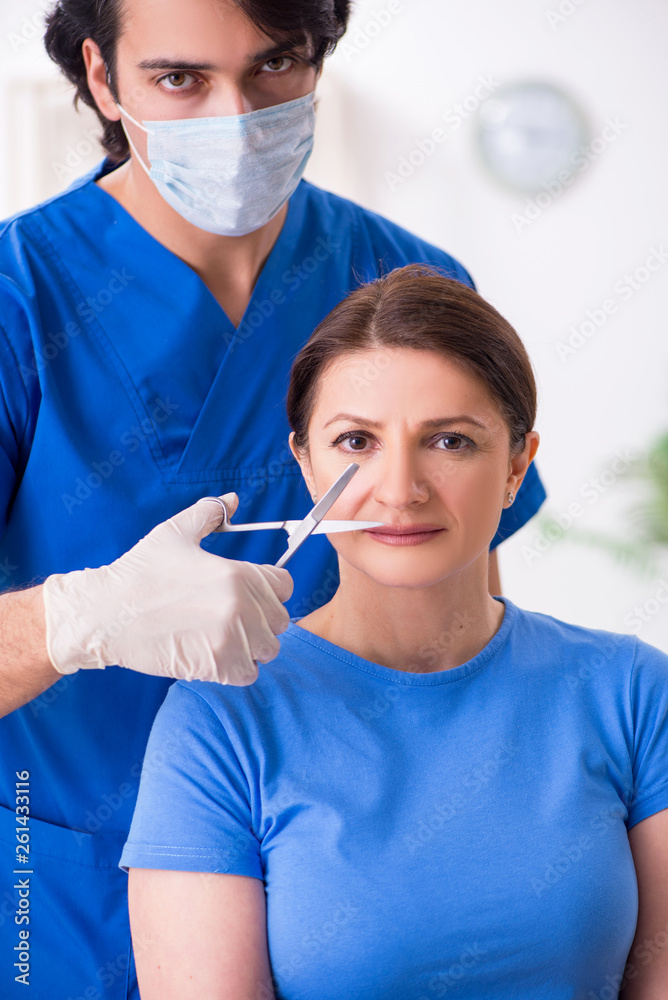 Woman visiting male doctor for plastic surgery Woman visiting male doctor for plastic surgery