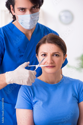 Woman visiting male doctor for plastic surgery 