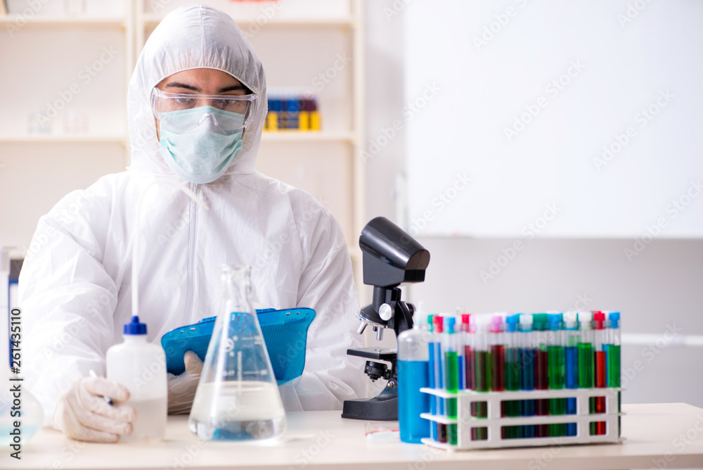 Young handsome chemist working in the lab Young handsome chemist working in the lab