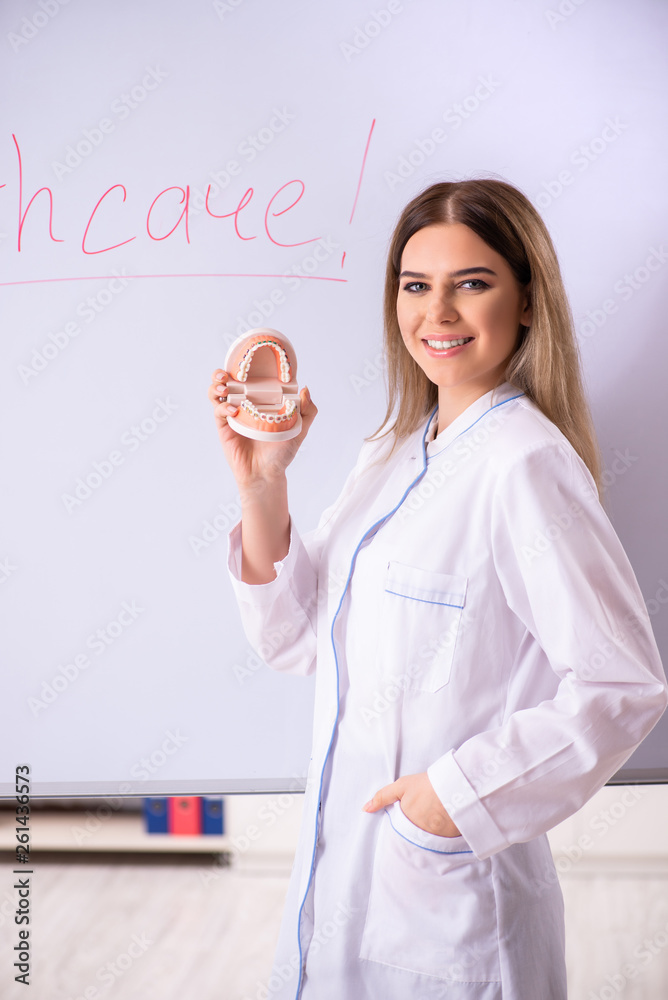 Young female doctor standing in front of the white board Young female doctor standing in front of the white board