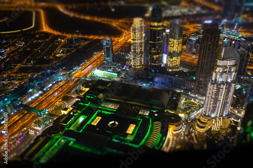 Aerial view of the illuminated night city. Tilt-shift effect.