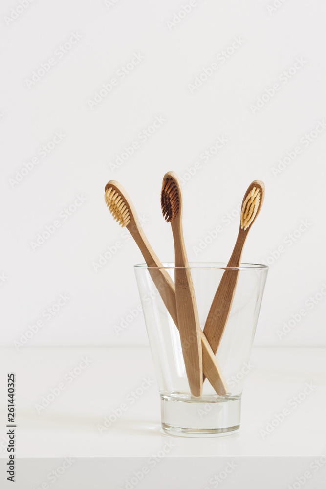 Fototapeta Bambusowe szczoteczki do zębów z naturalnym włosiem w szkle w łazience w stylu skandynawskim