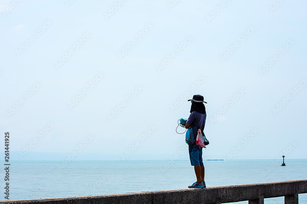 Man holding fishing nets  Background sea and sky.