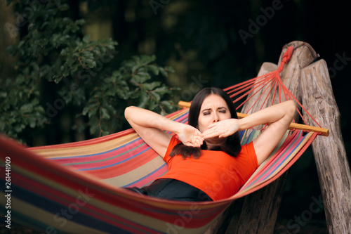 Sleepy Woman Relaxing in Hammock on Summer Vacation