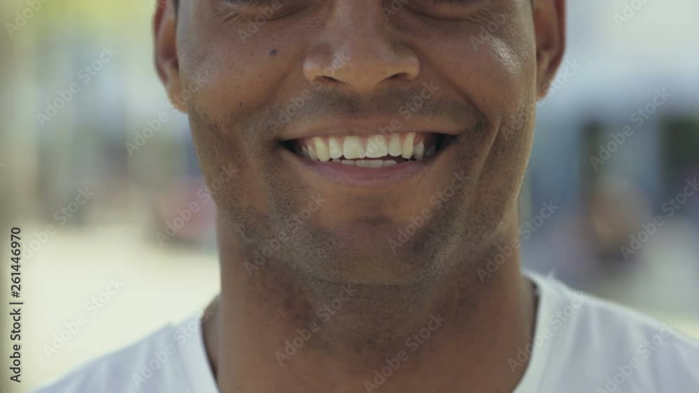 Cropped shot of smiling African American man. Toothy smile of happy young guy. Face features concept Cropped shot of smiling African American man. Toothy smile of happy young guy. Face features concept
