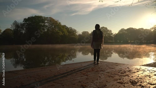 Atlanta, USA - April 04, 2019 : Woman walk alone in the lake side early morning.