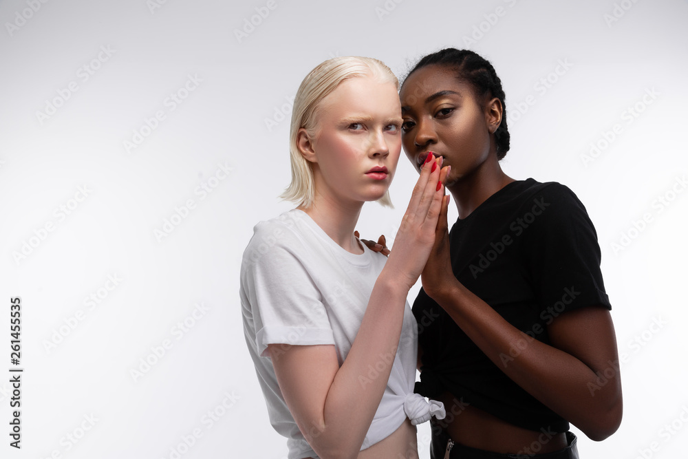 Models with different skin color touching their palms while posing Models with different skin color touching their palms while posing