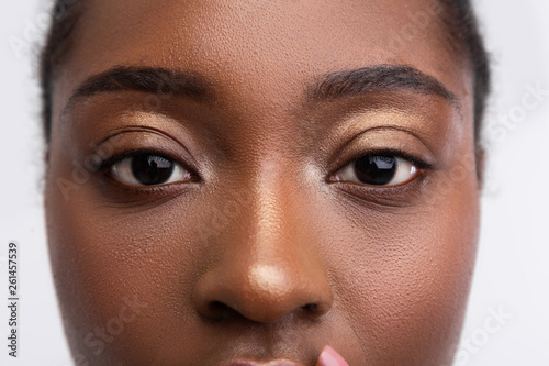 Dark-skinned young woman with nice golden eyeshades