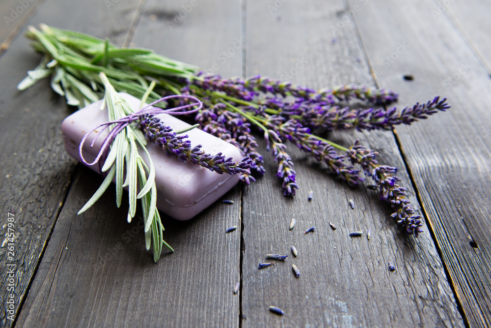 lavender soap and flowers on old black wooden table lavender soap and flowers on old black wooden table