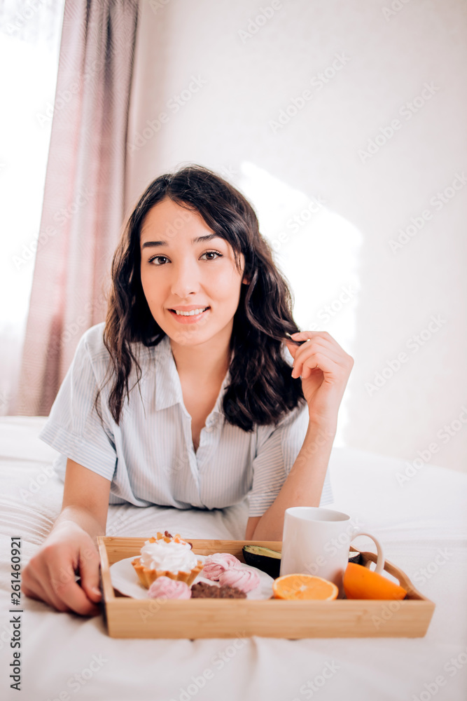 Young woman eating healthy breakfast in bed Young woman eating healthy breakfast in bed