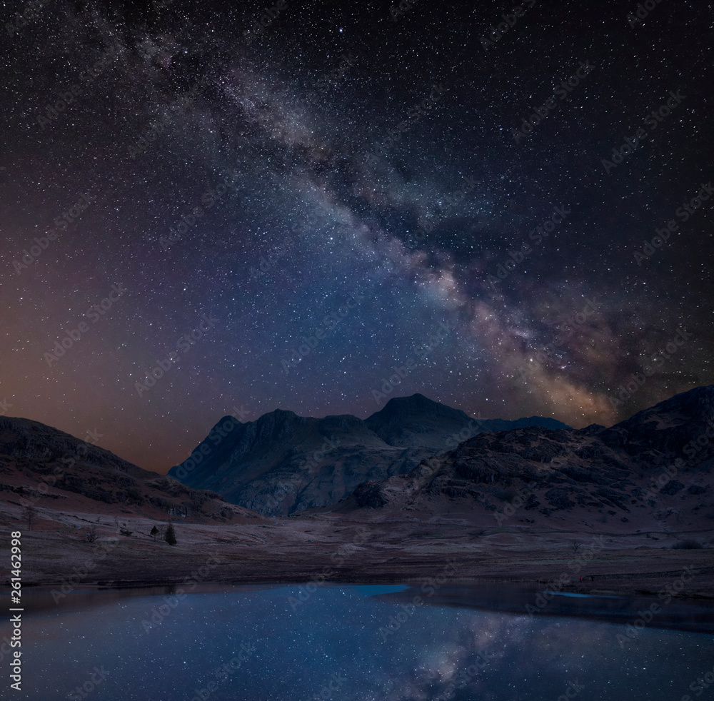 Fototapeta premium Digital composite image of Milky Way over beautiful landscape image of Blea Tarn in UK Lake District
