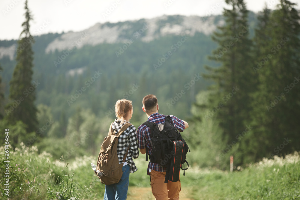 Couple walking in deep forest