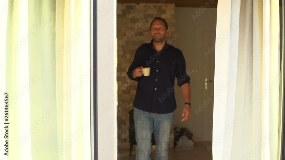 Man drinking coffee, walk out on terrace, slow motion