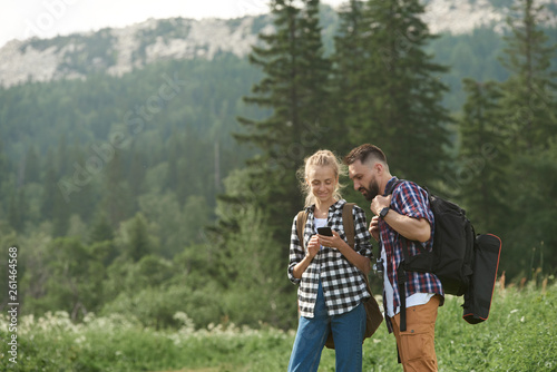 Couple navigate with smart phone while hiking