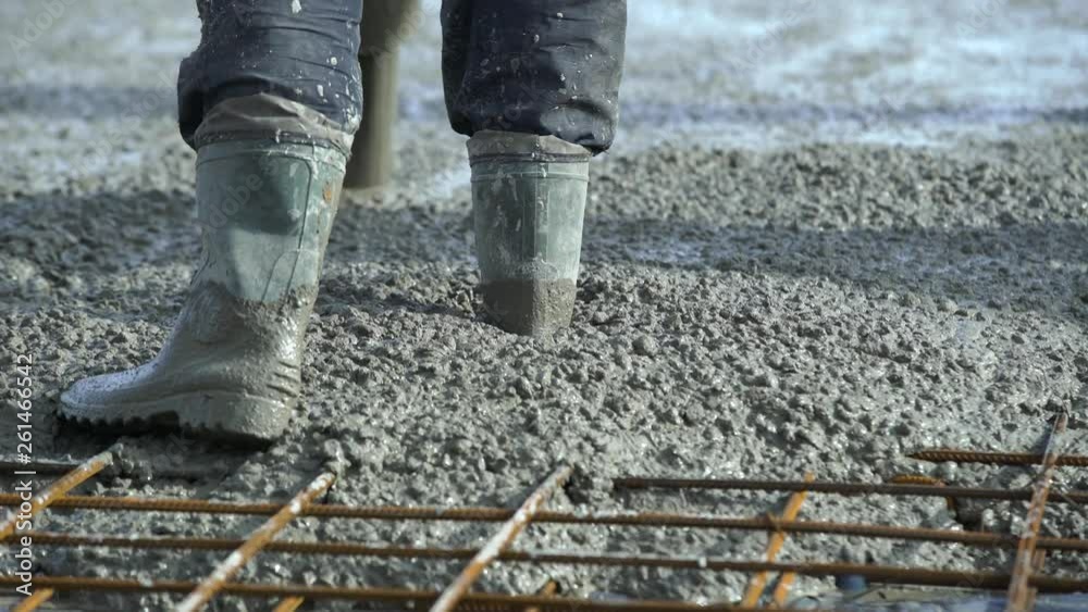 Concrete pours from the pipe into the foundation. Workers concrete the building, rebar, pour cement mortar from pump concrete mixer. Concrete pump works on construction