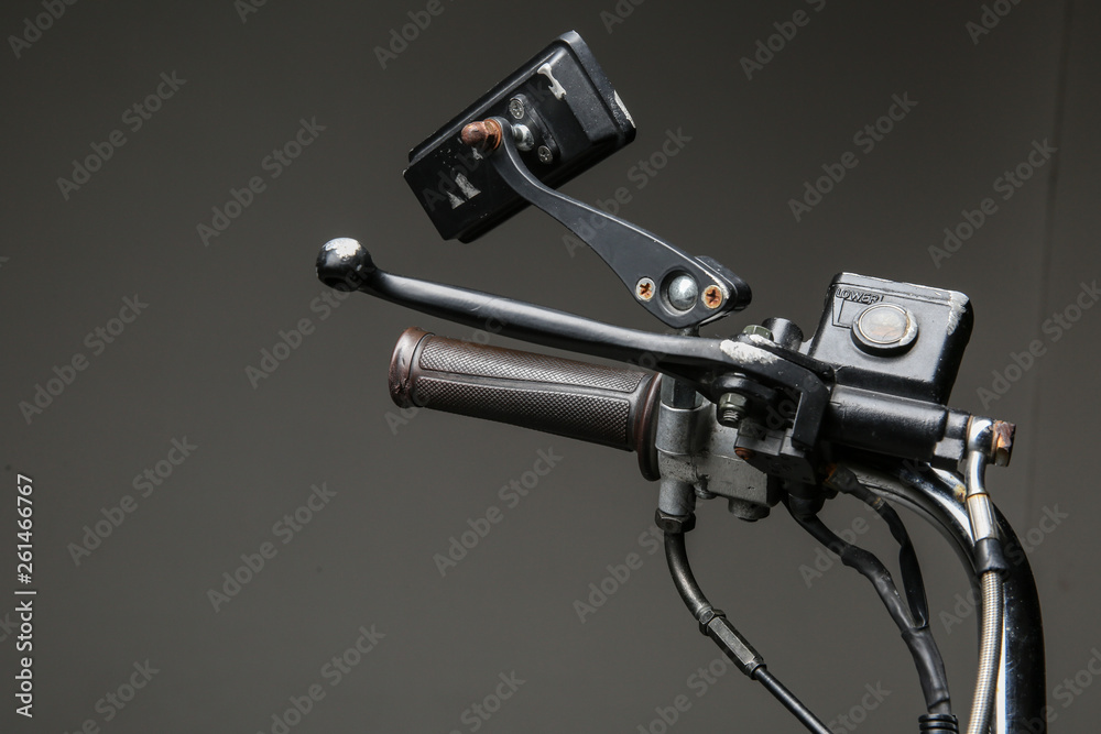 parts of retro motor scooter closeup on white background. tank of brake fluid on the scooter handlebar. brake master cylinder on motorcycle handlebar. 