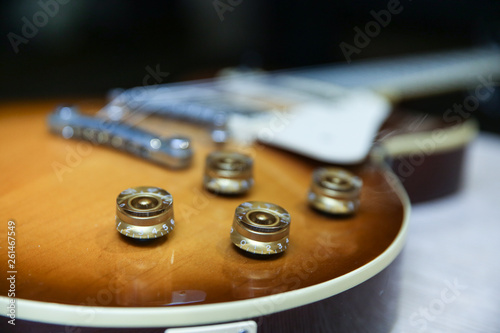 part of the body of an electric guitar. volume and tone control knobs of electic guitar. 