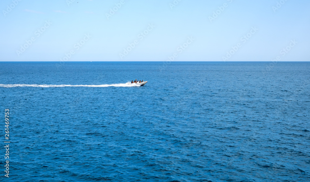 inflatable rib boat cruising in high speed in clear water sea