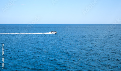 inflatable rib boat cruising in high speed in clear water sea