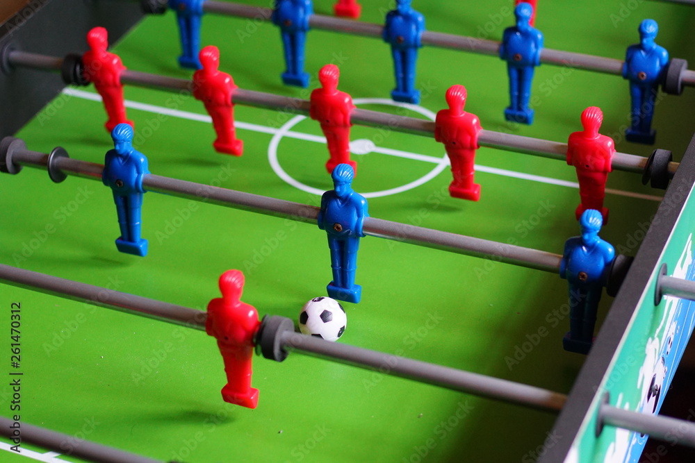 A close up of a table football game with red and blue players A close up of a table football game with red and blue players