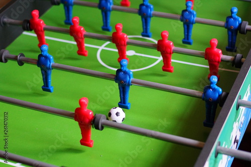 A close up of a table football game with red and blue players