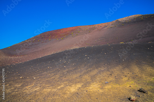 Spain, Lanzarote, Colorful stones of volcanic origin on volcanic mount in timanfaya volcano area photo