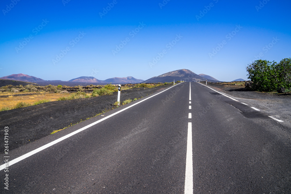 Spain, Lanzarote, Endless straight road through beautiful volcanic nature landscape