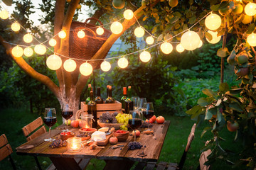 Rustic table with appetizers and wine in the evening
