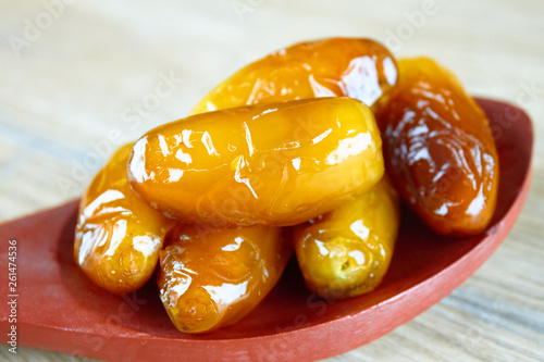 sweet algerian dates fruits on wooden spoon