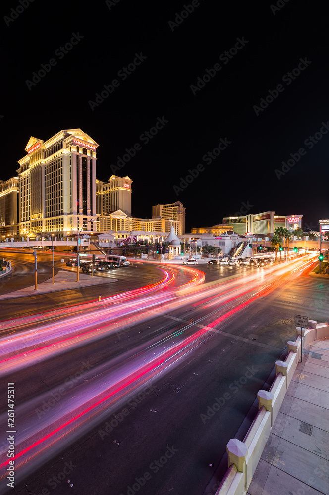 Las Vegas, Nevada / USA - 09.03.2015: Cars at the junction of South Las Vegas Boulevard and West Flamingo Road in front of Caesars Palace on the Las Vegas strip at night.