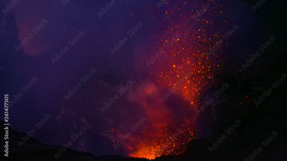 CLOSE UP: Dangerous volcanic eruption spewing lava from the depths of a crater.