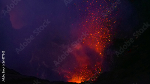 CLOSE UP: Dangerous volcanic eruption spewing lava from the depths of a crater. © helivideo