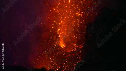 CLOSE UP  Stunning shot of a volcano erupting and spewing out hot lava at night.