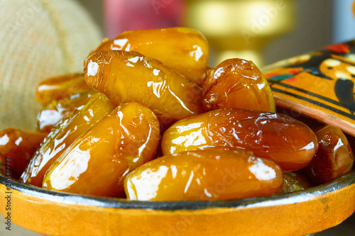 sweet algerian dates fruits on arabic traditional pottery plate