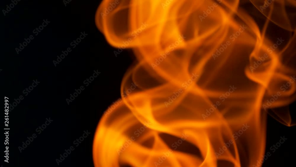 Thin trickle of fiery orange-red smoke slowly rising graceful twists up on black background. Colored smoke blowing from bottom to top. Closeup Thin trickle of fiery orange-red smoke slowly rising graceful twists up on black background. Colored smoke blowing from bottom to top. Closeup