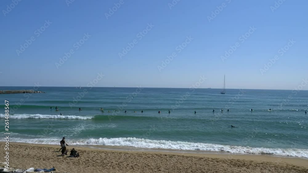 Surfers at beach on a sunny day. Barcelona. Spain. Flat plane Surfers at beach on a sunny day. Barcelona. Spain. Flat plane