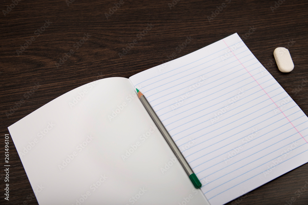 School notebook paper. Notebook in line and pencil. open notebook on a brown background. planning. stationery School notebook paper. Notebook in line and pencil. open notebook on a brown background. planning. stationery