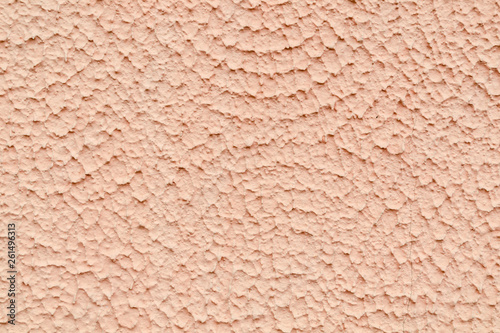 The texture of the wall covered with plaster and painted beige paint