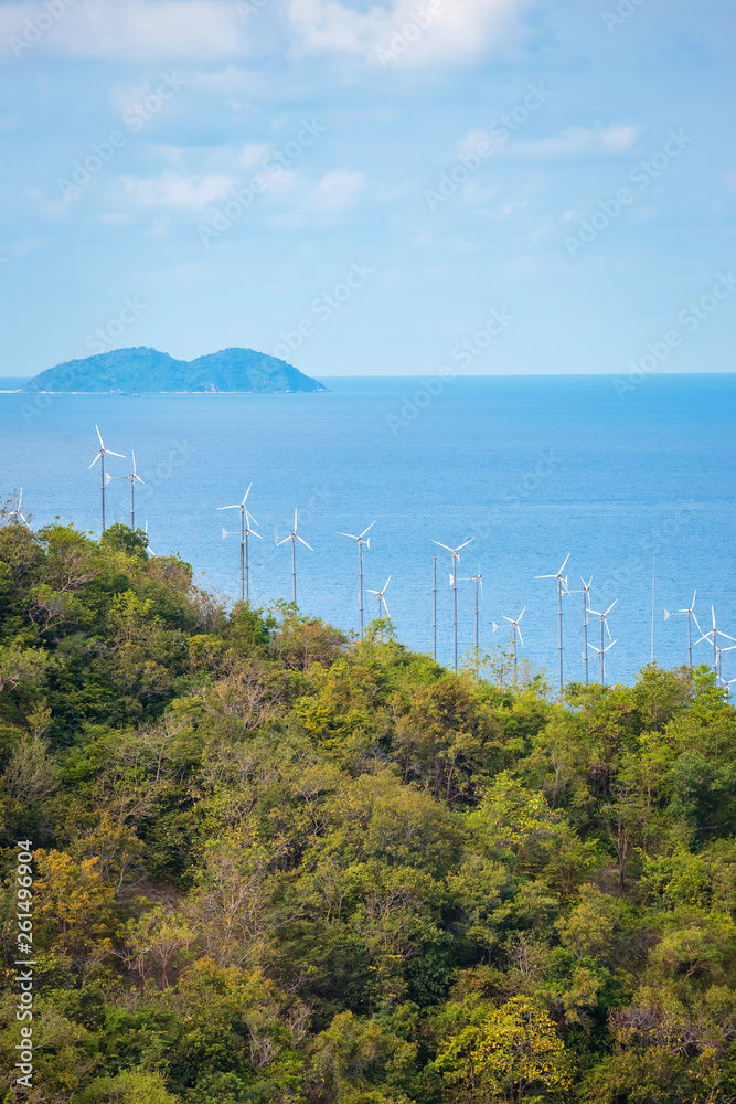 Obraz premium wind turbine generating electricity on mountain near sea.