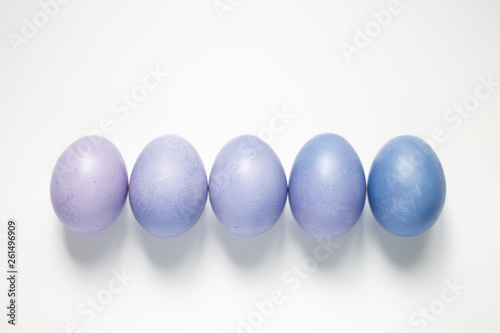 painted eggs on a light purple background Easter