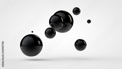 3D image of black balls in space. Balls of different sizes isolated on white background. Abstract, futuristic image of contrast of black and white. 3D rendering, illustration.