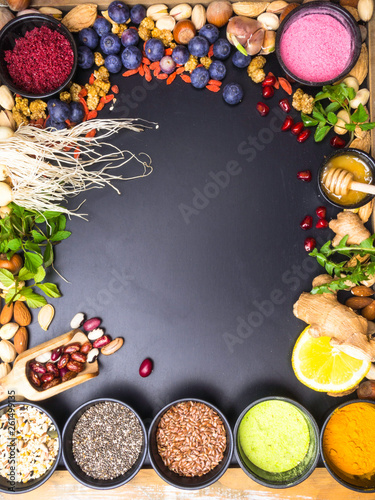 Superfoods on dark wooden table