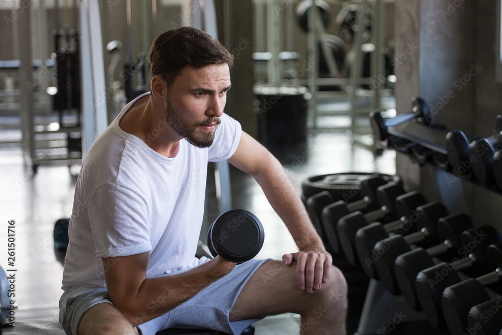 fitness man doing exercises sitting with weight lifting dumbbells in gym . sport young male training .work out healthy fitness man doing exercises sitting with weight lifting dumbbells in gym . sport young male training .work out healthy