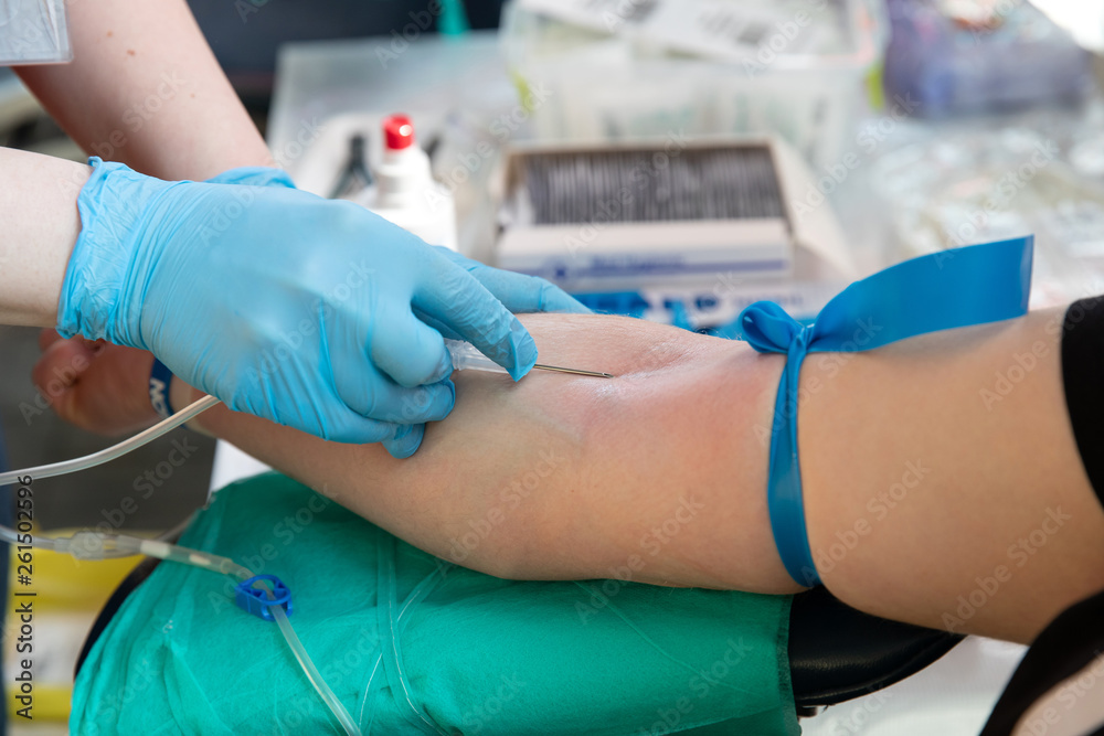 Blood donor at donation. Nurse receiving blood from blood donor Blood donor at donation. Nurse receiving blood from blood donor