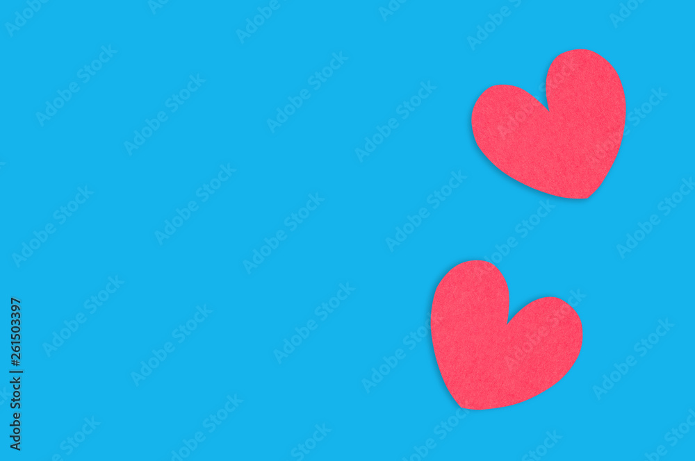Two red paper hearts on blue table. Top view. Valentines Day concept. Copy space for your text