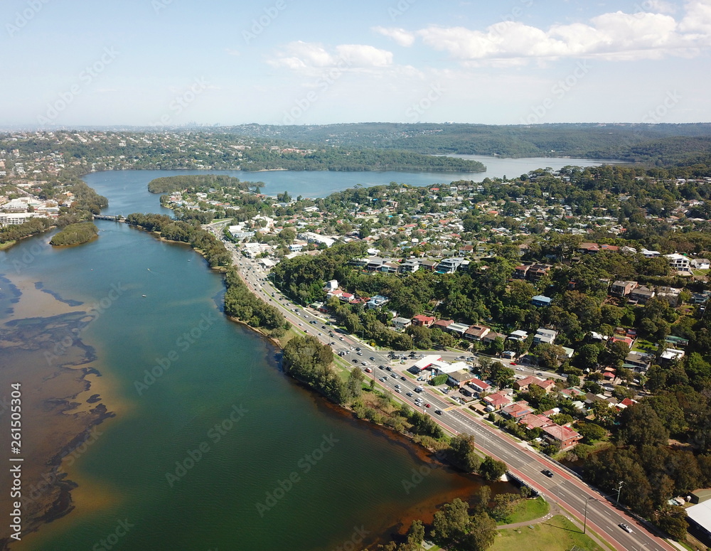 Aerial view of Narrabeen Lake. Sydney CBD in the background.