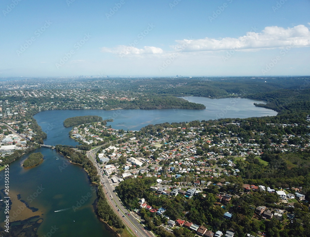 Aerial view of Narrabeen Lake. Sydney CBD in the background.