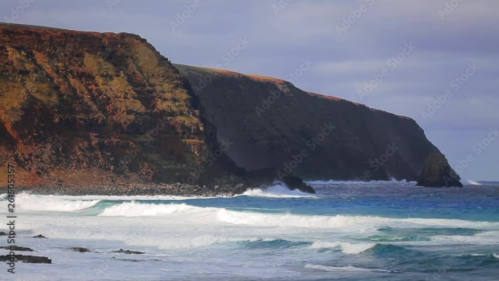 Ocean waves crash onto the dramatic and powerful cliff break. Remote uncrowded location perfect for surfing. Ocean waves crash onto the dramatic and powerful cliff break. Remote uncrowded location perfect for surfing.